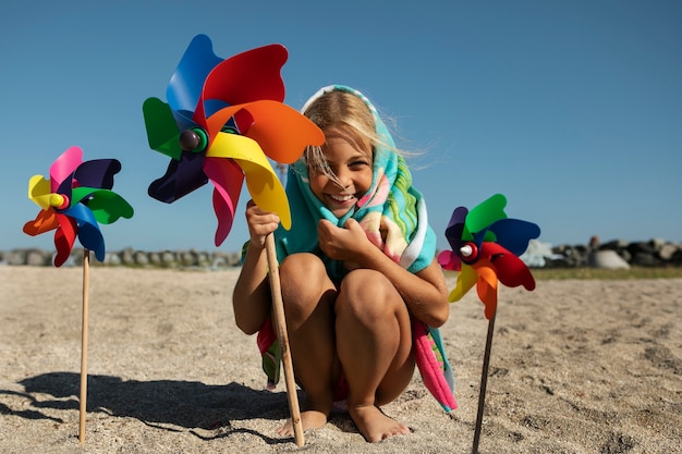 Full shot smiley girl on beach